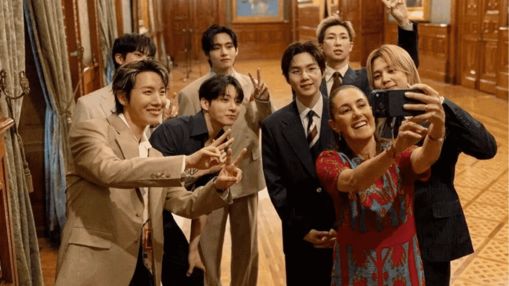 Bts Posing for a Selfie in a Wood-paneled Room, Making Peace Signs with Smiling Faces at the Camera to Capture a Moment Together Geared in Suits and a Red Dress at the Front.