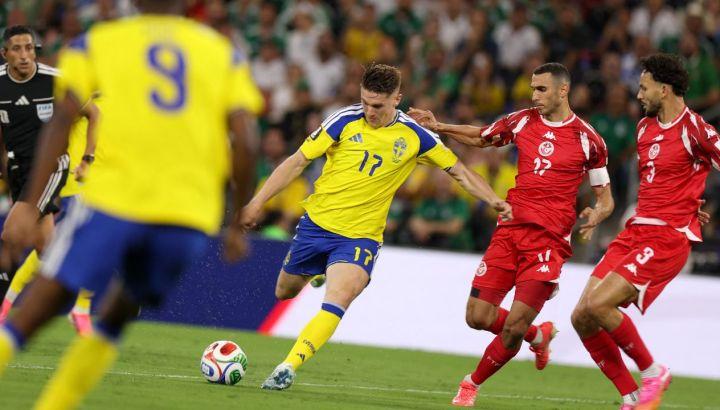 Sweden Player in Yellow (number 17) Kicks the Ball As Two Red-team Defenders Close in During a Soccer Match, with a Crowd in the Stands. › Guadalupa Ciudadana